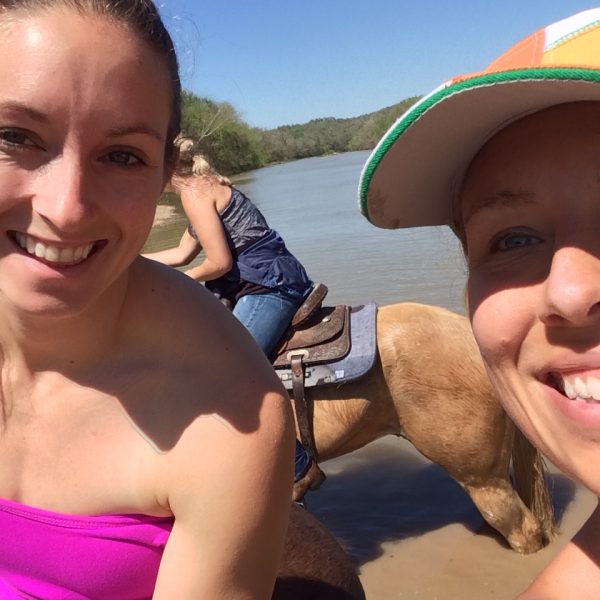 two women horseback riding in the colorado river