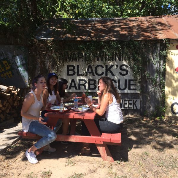 Group of visitors from Australia takes a lunch break with head guide Kathryn Hetzendorfer at Black's BBQ for a river ride to downtown Lockhart