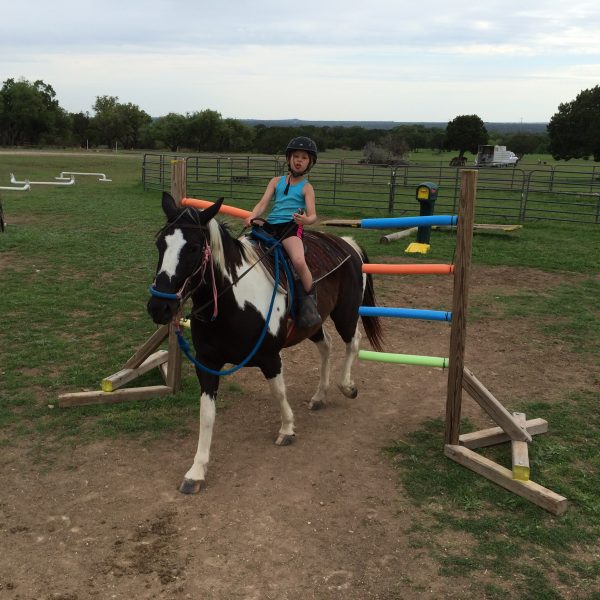 Blue, orange and green summer pool noodles create the perfect horseback riding obstacle, as demonstrated by youth play day rider on APHA mare, Coca