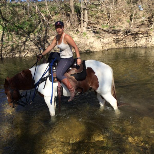 big stout paint gelding for sale pictured with trainer and natural horsemanship enthusiast, MacCoy, in the river of Brushy waters of Texas