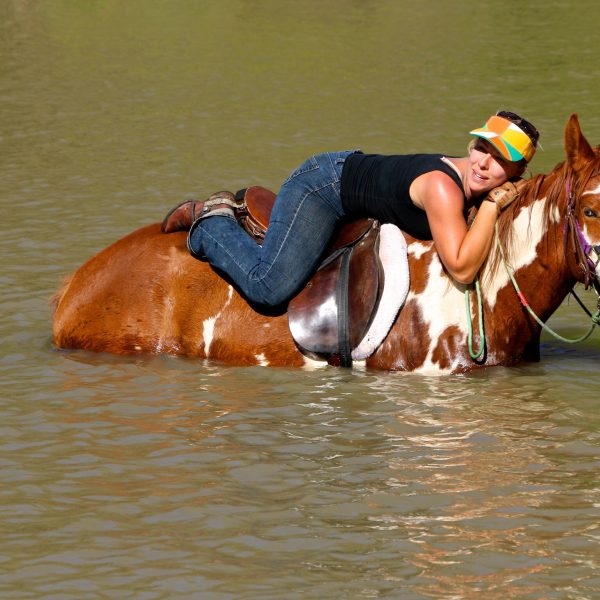 Rider lying down on the job with APHA mare, Annie Up, who is currently serving Maverick Stables as a beautiful broodmare